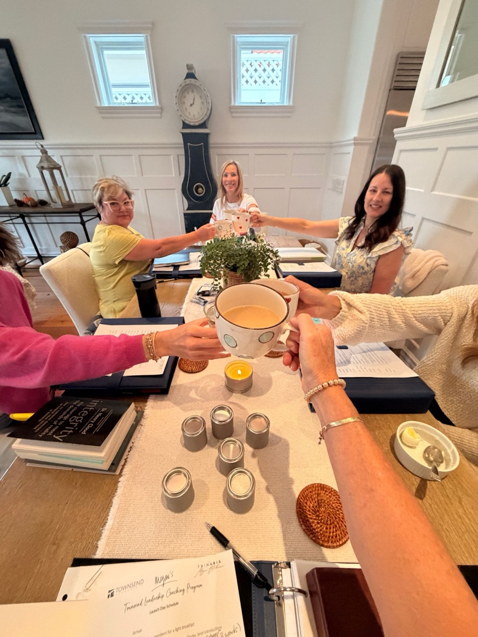 A Growth Group raising coffee mugs in a toast on launch day