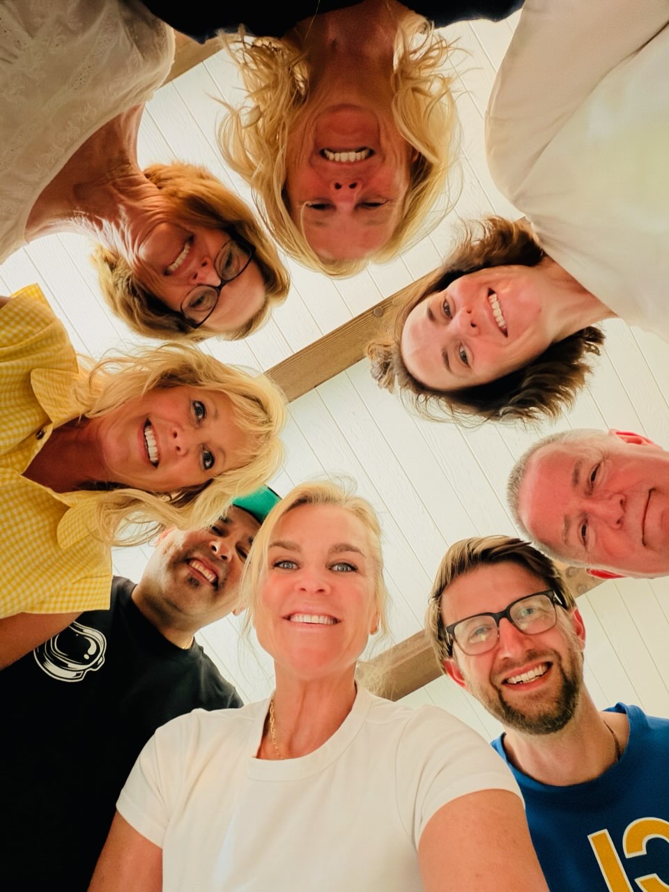 Megan and a Growth Group smiling down at the camera in a huddle