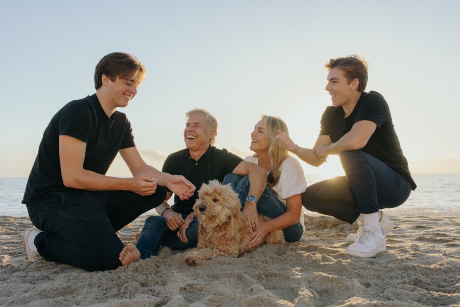 Megan with her husband, their two sons, and their dog on the beach